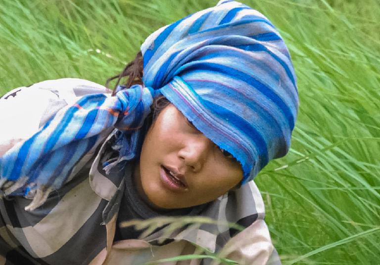 Close-up of a grandmother wearing a traditional krama scarf